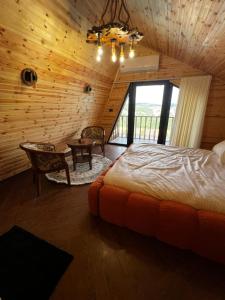 a bedroom with a bed and a table in a room at أكواخ غصُن عجلون in Ajloun +10 photos