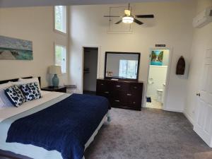 a bedroom with a bed and a ceiling fan at Creekside Oasis in Lusby
