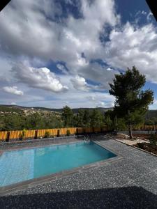 a swimming pool in a yard with a fence at أكواخ غصُن عجلون in Ajloun