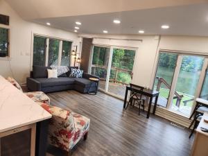 a living room with a couch and a table at Creekside Oasis in Lusby