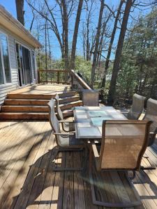 a patio with a table and chairs on a deck at Creekside Oasis in Lusby