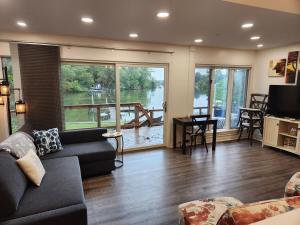 a living room with a couch and a view of a lake at Creekside Oasis in Lusby