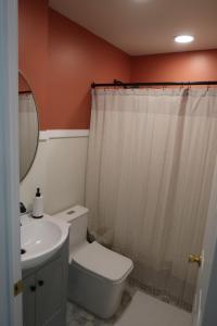 a bathroom with a white toilet and a sink at Creekside Oasis in Lusby +38 photos