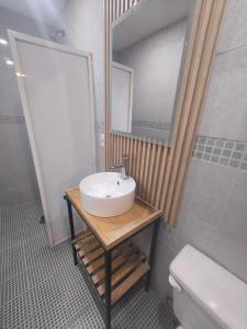 a bathroom with a sink and a mirror and a toilet at Hotel Torreon in Mexico City