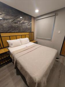 a bedroom with a large white bed in a room at Hotel Torreon in Mexico City