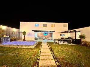 a house with a pool in the yard at night at Modern house with pool in Ica in Ica