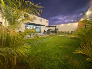 a yard of a house with a grassy yard at Modern house with pool in Ica in Ica