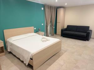 a bedroom with a bed and a black couch at Sofia s Rooms in Falcone