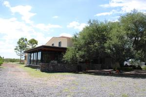 a house on the side of a gravel road at Casa Ancestra in Santa Cruz
