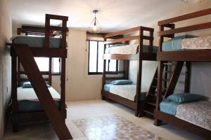 a bedroom with four bunk beds in a room at Casa Ancestra in Santa Cruz