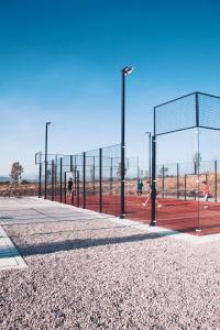 a group of people playing tennis on a tennis court at Casa Ancestra in Santa Cruz +8 photos