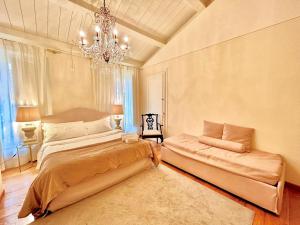 a bedroom with two beds and a chandelier at Camilla Garden in Pisa