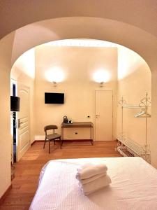 a bedroom with a bed and a desk with a television at Camilla Garden in Pisa +21 photos