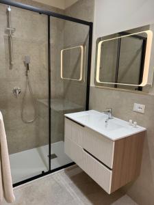 a bathroom with a shower and a sink and a mirror at Sofia s Rooms in Falcone +58 photos