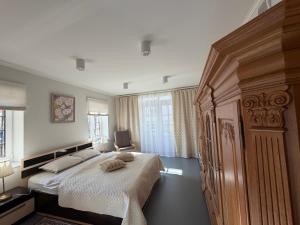 a bedroom with a large bed and a window at Mazais Namiņš in Jelgava