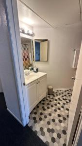 a bathroom with a sink and a mirror at Steps from UCLA Westwood 1 Bd 1Ba in Los Angeles