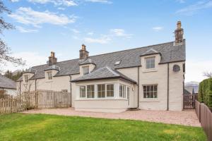 an exterior view of a large white house at 3 Bed in Lairg oc-96459 in Achfary