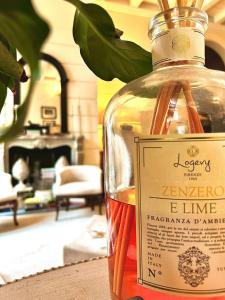 a bottle of alcohol sitting on a table in a living room at Camilla Garden in Pisa