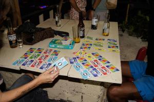 two people sitting at a table playing a game at TerraZica hostal in Brisas de Zicatela +25 photos