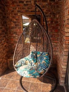 a hanging basket with a blanket in a room at Romaic Guesthouse Welkom in Welkom