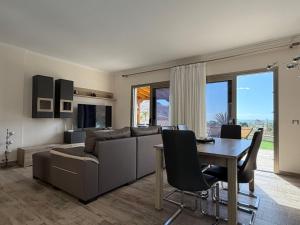 a living room with a couch and a table at Villa Sunset Tauro in Mogán
