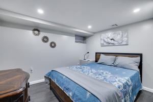 a bedroom with a bed with a blue comforter at 4BR Newark Stay w/ Parking And Fast Wi-Fi in Newark