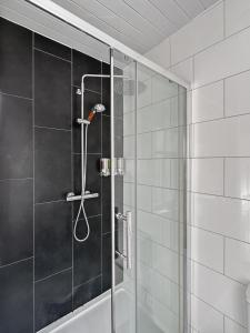 a shower with a glass door in a bathroom at Granada Apartments Queen's Promenade in Blackpool +217 photos