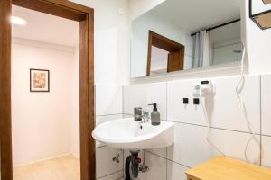 a bathroom with a sink and a mirror at Bergsonnen-Stuben in Bad Lauterberg +160 photos