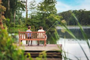 two people sitting on a bench fishing on a lake at Callaway Resort & Gardens in Pine Mountain +157 photos