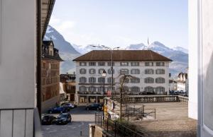 a view of a city with mountains in the background at Cara Nima Schwyz in Schwyz