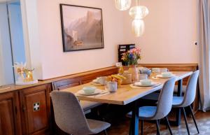 a dining room with a wooden table and chairs at Cara Nima Schwyz in Schwyz