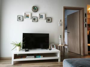 a living room with a television on a white entertainment center at FoBala Apartman in Balatonföldvár