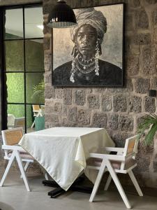 a table with a portrait of a black woman at Ndare Eco Ville in Kigali