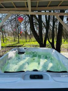 a jacuzzi tub sitting under a gazebo at Varázslakos Tanya in Soltvadkert