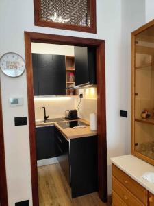 a small kitchen with a sink and a mirror at La Casa dello Zio Pollo in Dogliani +16 photos