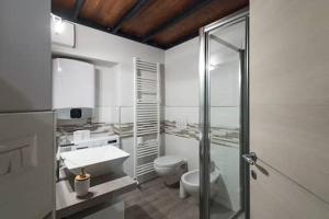 a bathroom with a toilet and a sink and a shower at Monolocale Piazza Garibaldi in Saluzzo