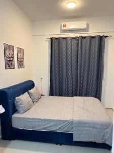 a bed with a blue frame in a room at Cloud9 Homestay D Aman Residence in Alor Setar