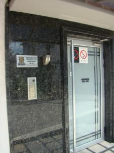 a glass door of a building with signs on it at Prenoćište Singidunum 4lux in Belgrade