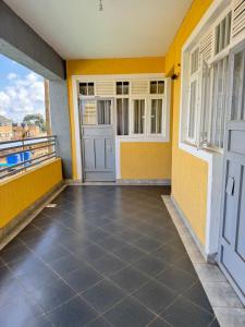 a room with a door and a balcony at Bella apartment studios town in Meru