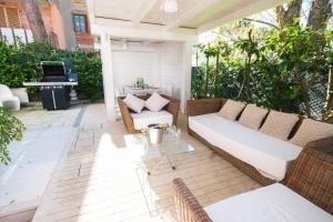 a patio with a white couch and a piano at Villa Irene in Cervia