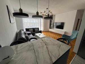 a living room with a couch and a table at Sonny Penthouse 2 in Gnjilane