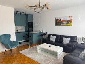 a living room with a couch and a coffee table at Sonny Penthouse 2 in Gnjilane