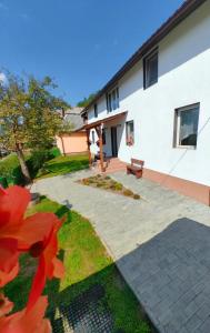 a building with a bench in front of it at Casa MATEO in Topliţa +13 photos