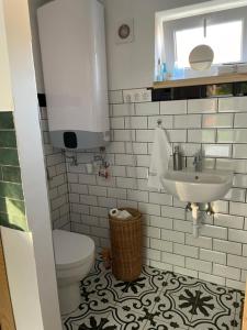 a bathroom with a toilet and a sink at Cirkusz Udvar in Kapolcs