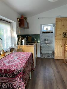 a kitchen with a table and a sink in a room at Cirkusz Udvar in Kapolcs
