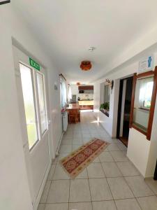 a hallway with a door and a tile floor at Casa MATEO in Topliţa