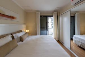 a bedroom with a large bed and a couch at Victoria Place By HX in São Paulo +57 photos