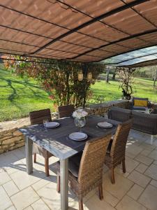 a table and chairs on a patio at Larroque Haute Gites in Cassagnes