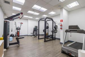 a gym with several tread machines and a treadmill at Delphin Beach Hotel - Suíte 238 in Guarujá
