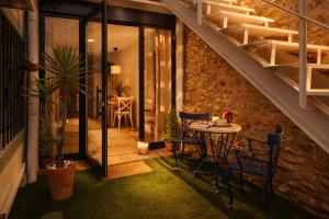 a room with a table and chairs and a staircase at Private Loft Sant Celoni, Montseny, Barcelona in Sant Celoni